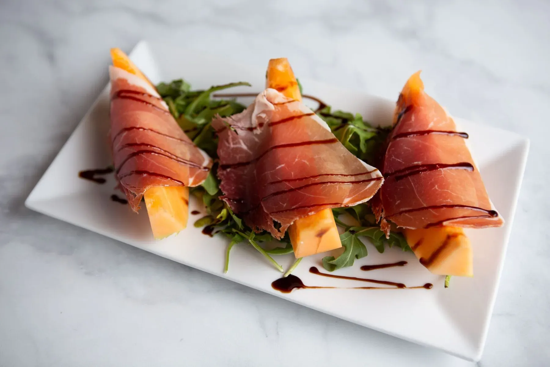 Prosciutto and melon dish served at Carmine’s